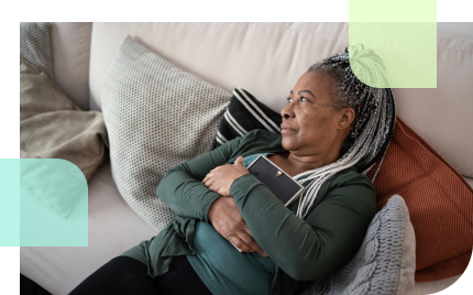 Older widowed woman, embracing a picture frame
